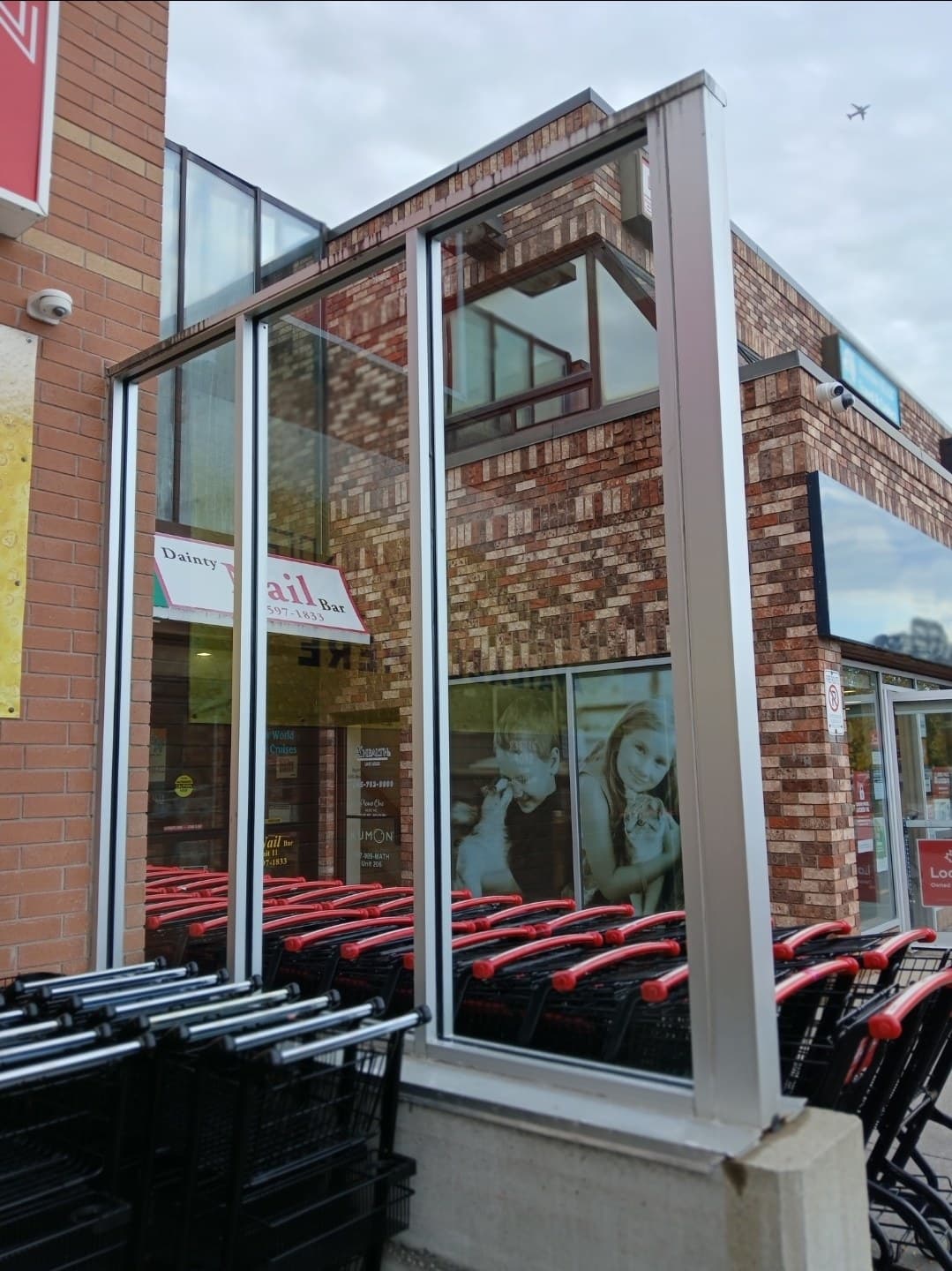 Plaza storefront glass cleaned to a bright shine