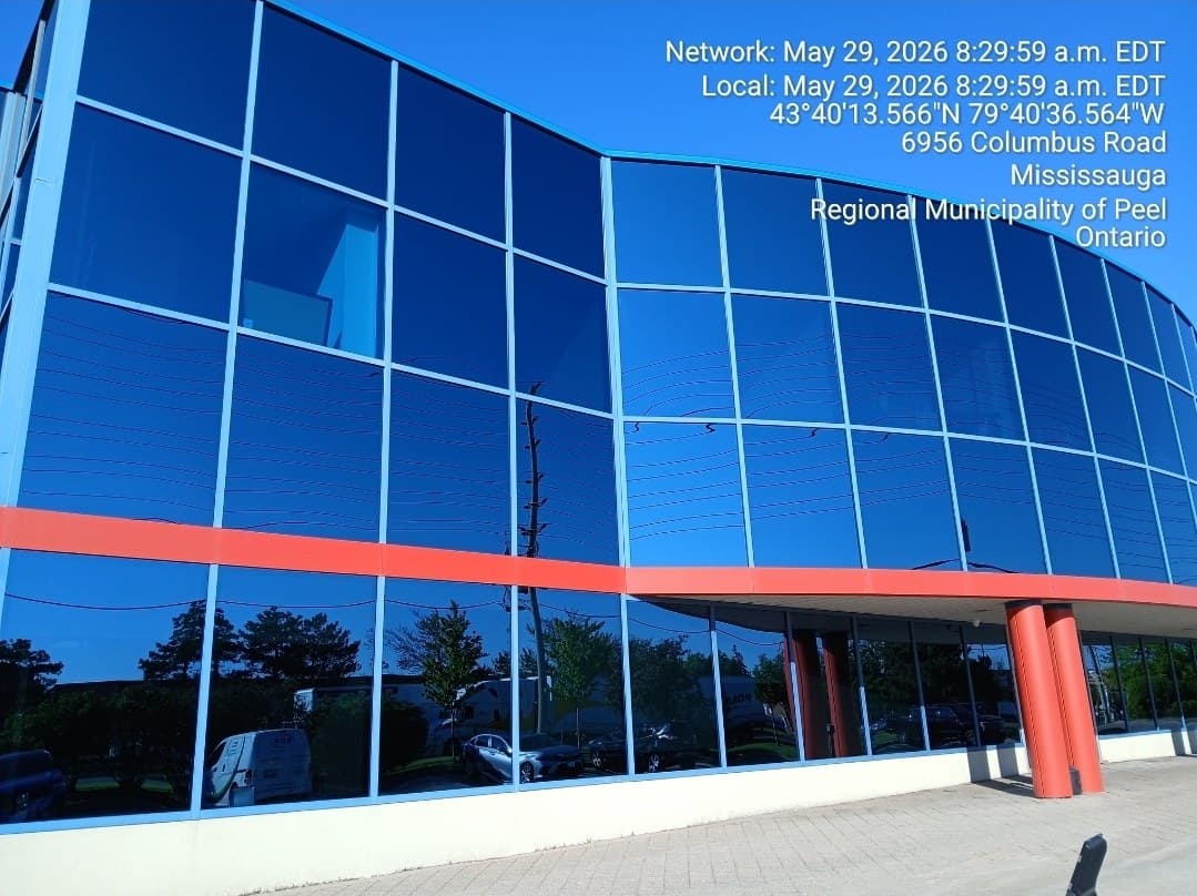 Spotless blue-glass commercial facade under clear sky